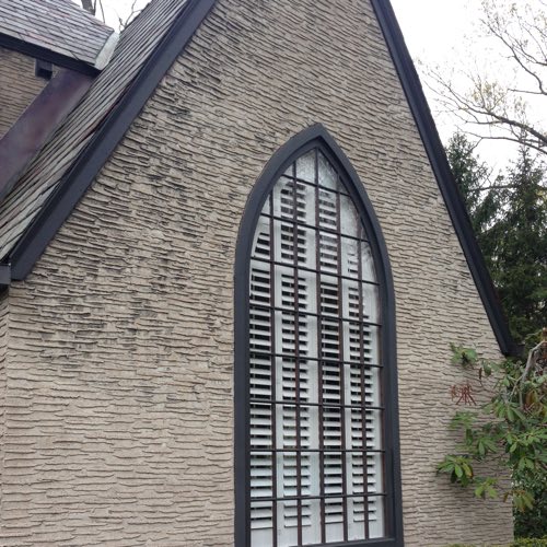 Exterior face of brick home with plantation shutters